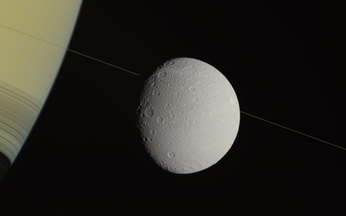 Saturn and its moon Dionne from the Cassini orbiter.